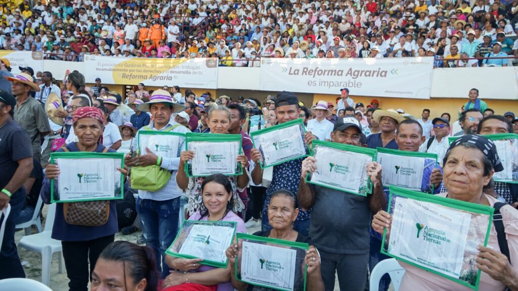 Campesinos sosteniendo sus títulos celebrando en el Coliseo de Ferias de Sincelejo (Sucre).