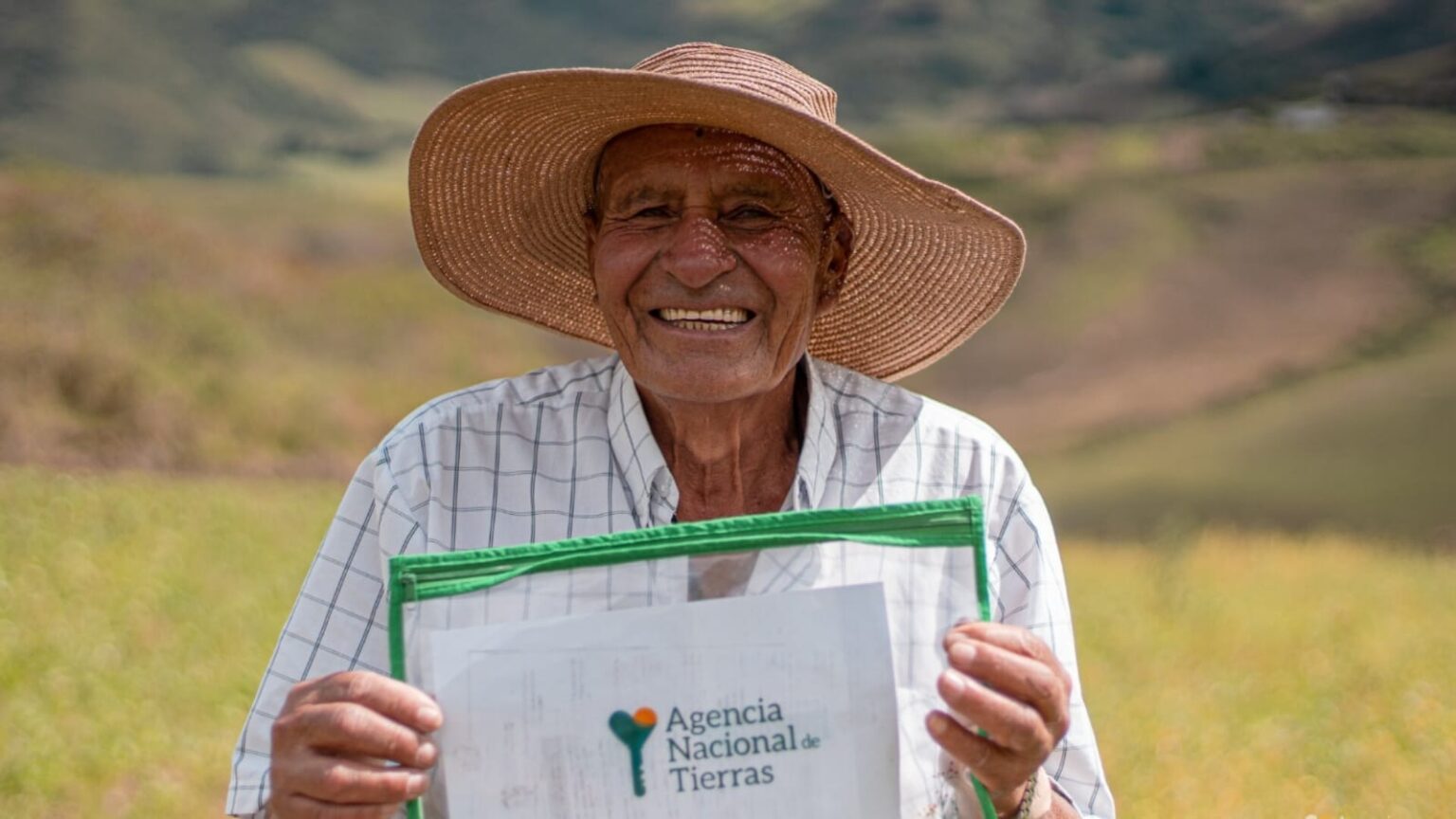Señor campesino sonriendo recibiendo su título.